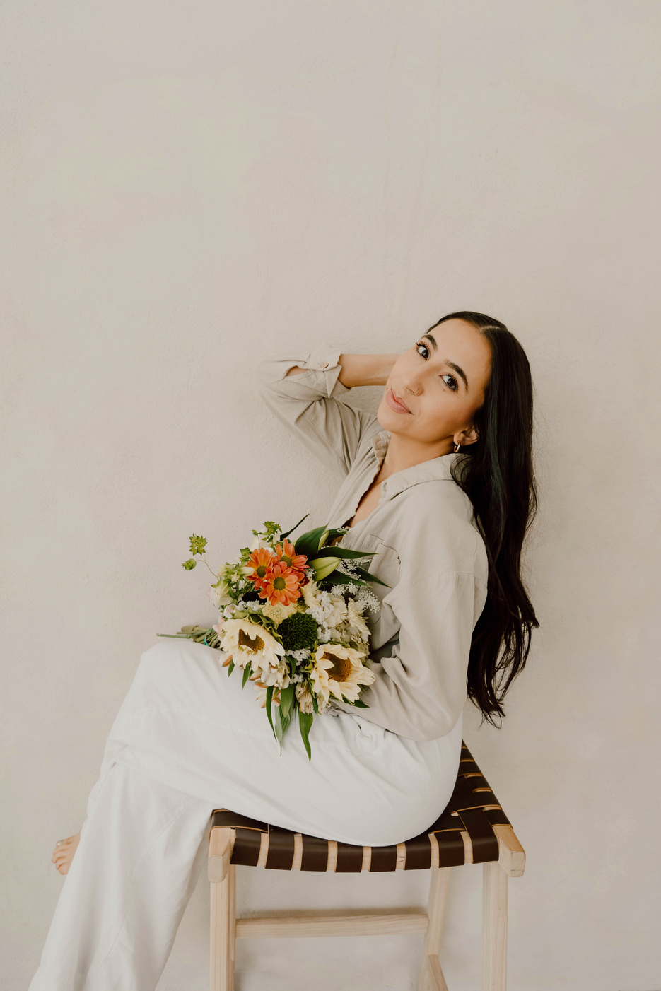 Celina seated with a bouquet of garden flowers