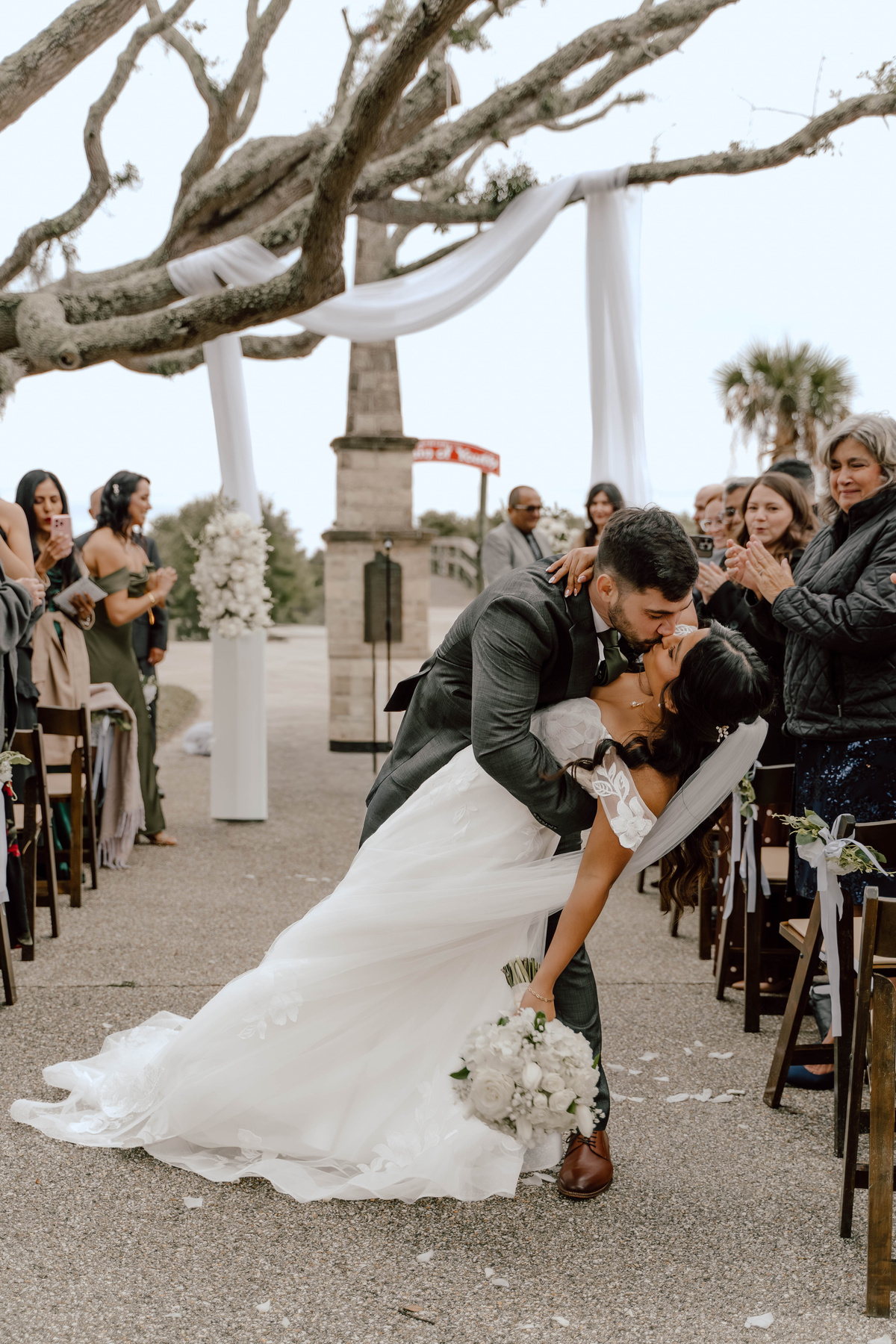 A wedding ceremony first kiss dip